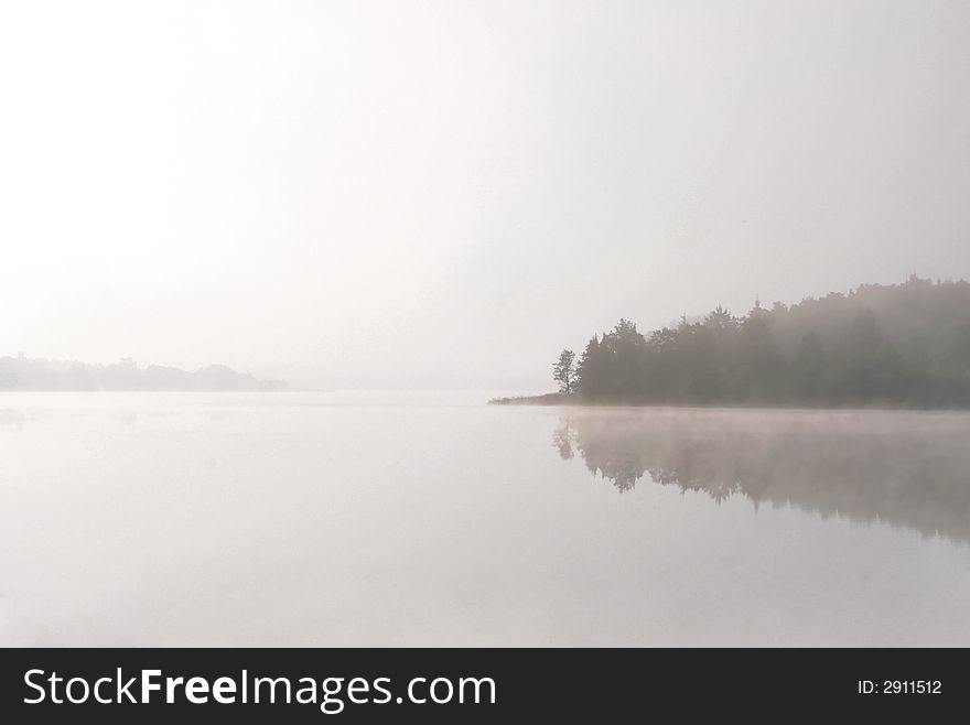 White morning lake in a fog