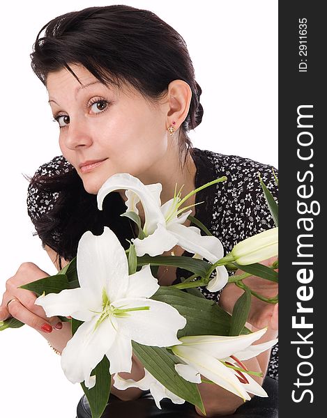 The attractive woman holds a bouquet of lilies in hands. The attractive woman holds a bouquet of lilies in hands