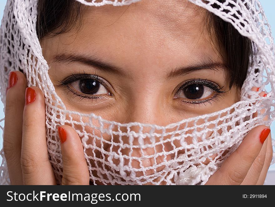 Beautiful woman wearing a white scarf with blue background. Beautiful woman wearing a white scarf with blue background