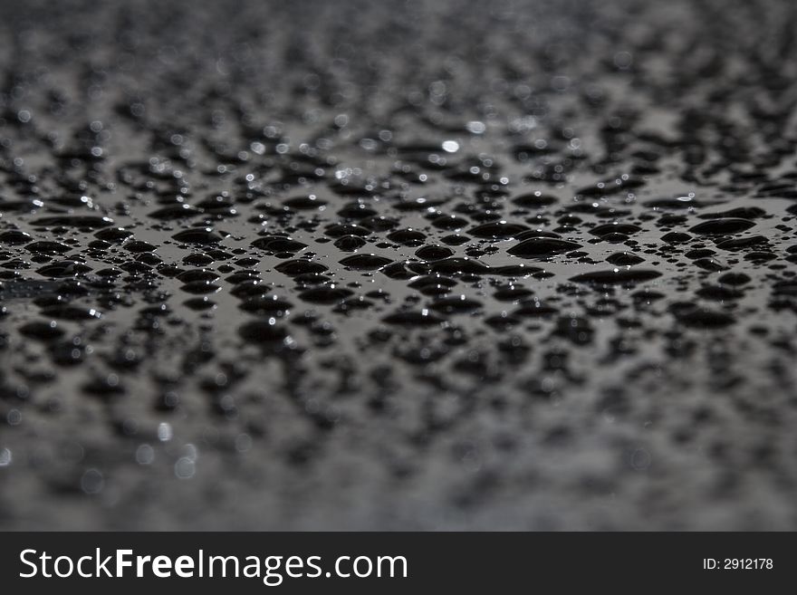 Water drops on a black surface