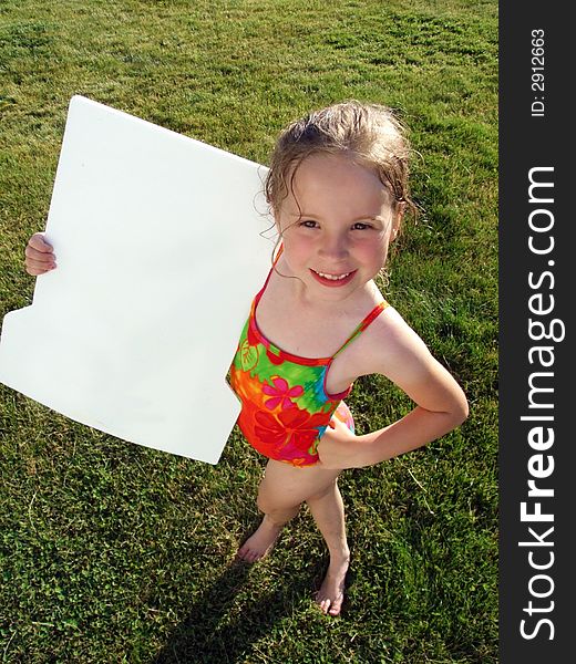 A smiling blonde girl holds a blank white poster board. A smiling blonde girl holds a blank white poster board.