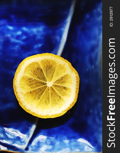 Slice of lemon on the blue plate