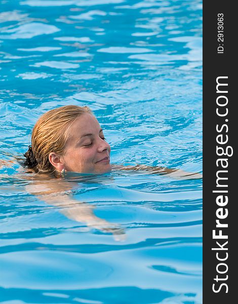 Girl swing in relaxing blue pool water. Girl swing in relaxing blue pool water