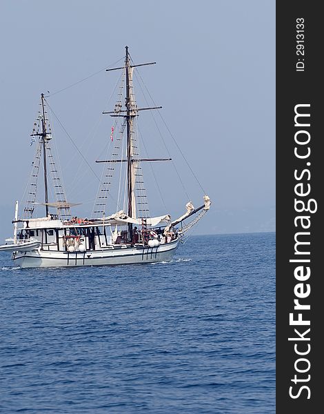 Old style white ship sailing in blue waters. Old style white ship sailing in blue waters