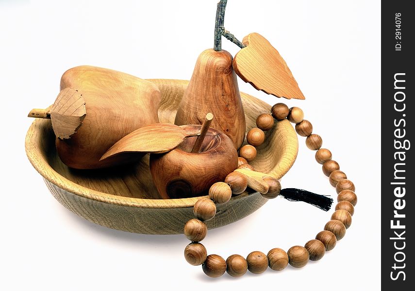 Scene of the still life from wooden fruit on white background