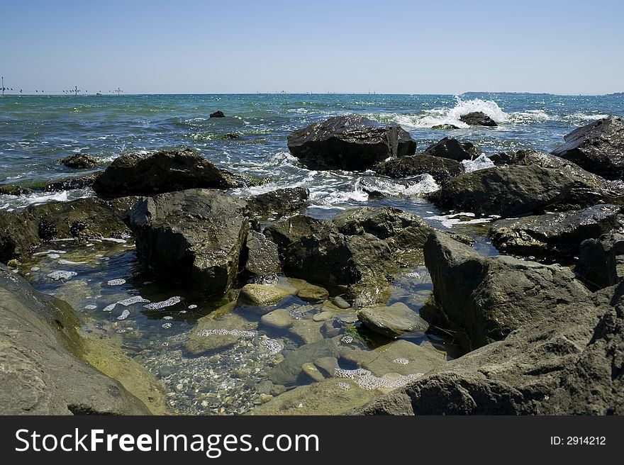 Rocks at Black Sea coast at hot summer day. Bulgaria, Sunny Beach. If you download this image, please let me know how you want to use it. This information is for my private use only. Thank you. Rocks at Black Sea coast at hot summer day. Bulgaria, Sunny Beach. If you download this image, please let me know how you want to use it. This information is for my private use only. Thank you.
