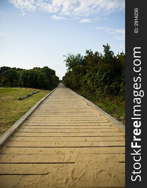 A sandy wooden boardwalk leading out to the beach.