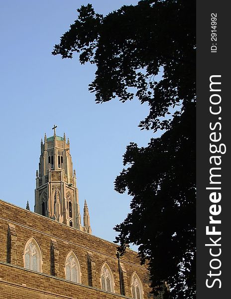 A church spire peeks over a building.