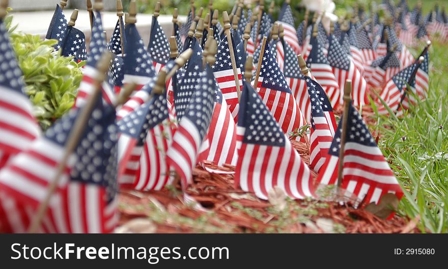 Small flags in front of a stone monument. Small flags in front of a stone monument