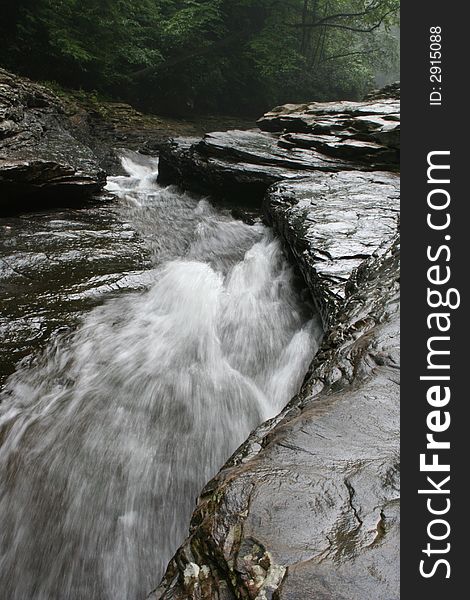 Water rushing down a tight rock formation. Water rushing down a tight rock formation.