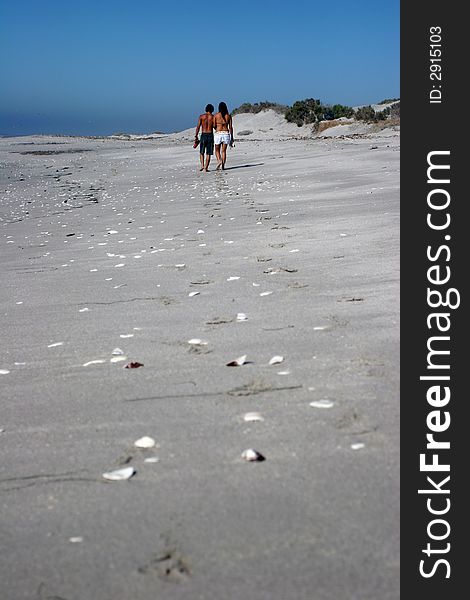 Two persons walking in the beach. Two persons walking in the beach