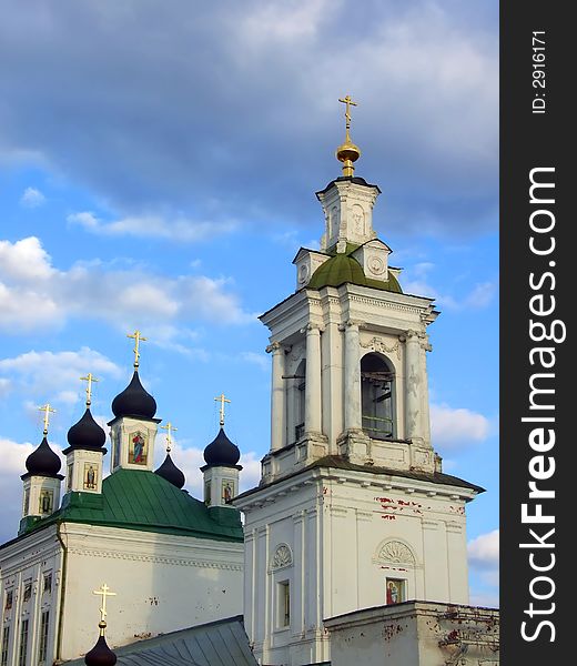 Old white orthodox church and celestial clouds