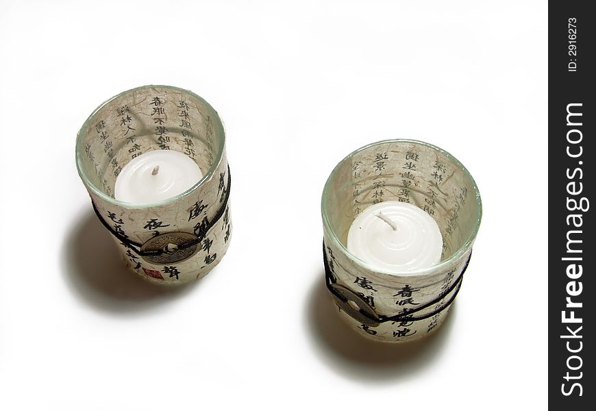 Chinese candlesticks with hieroglyphs and candles isolated