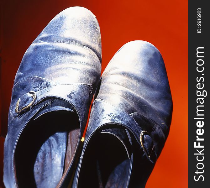 Old shoes on a red background. Old shoes on a red background