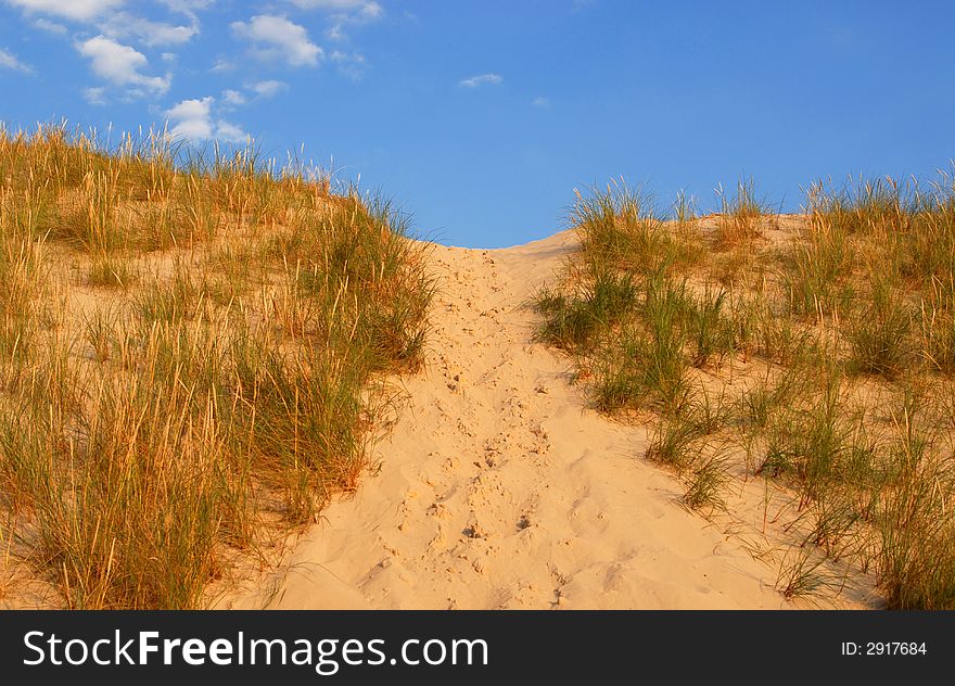 Dune way on the blue sky background