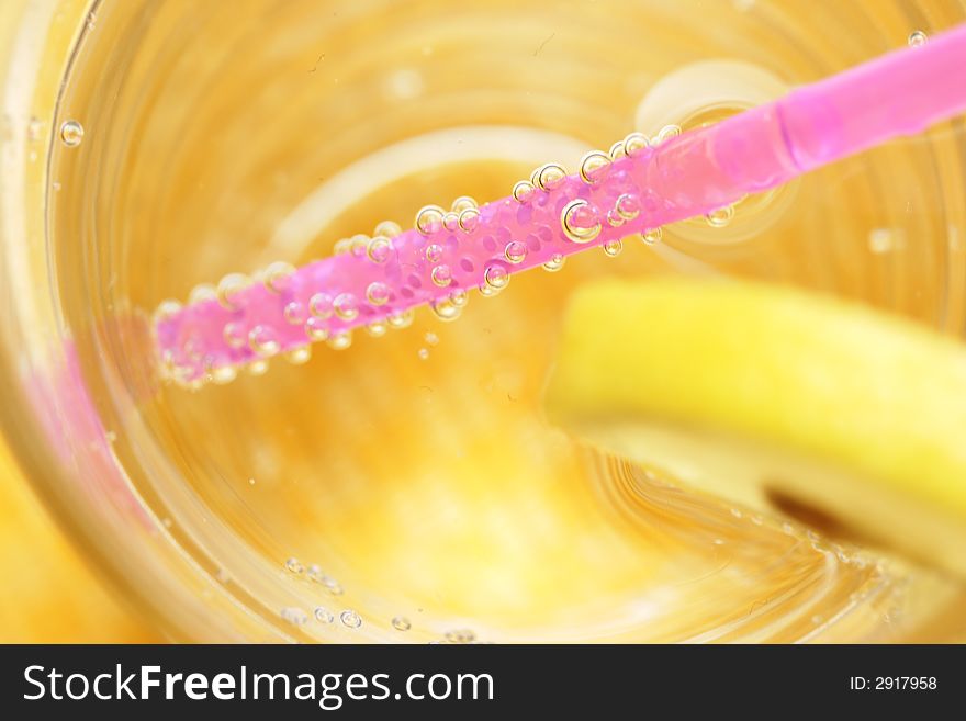 Water, sparkling, lemon, straw, glass. Water, sparkling, lemon, straw, glass