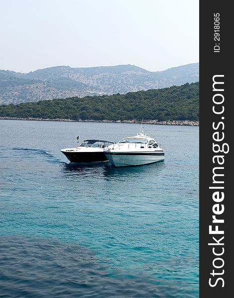 Blue and white luxury boats on sea. Blue and white luxury boats on sea