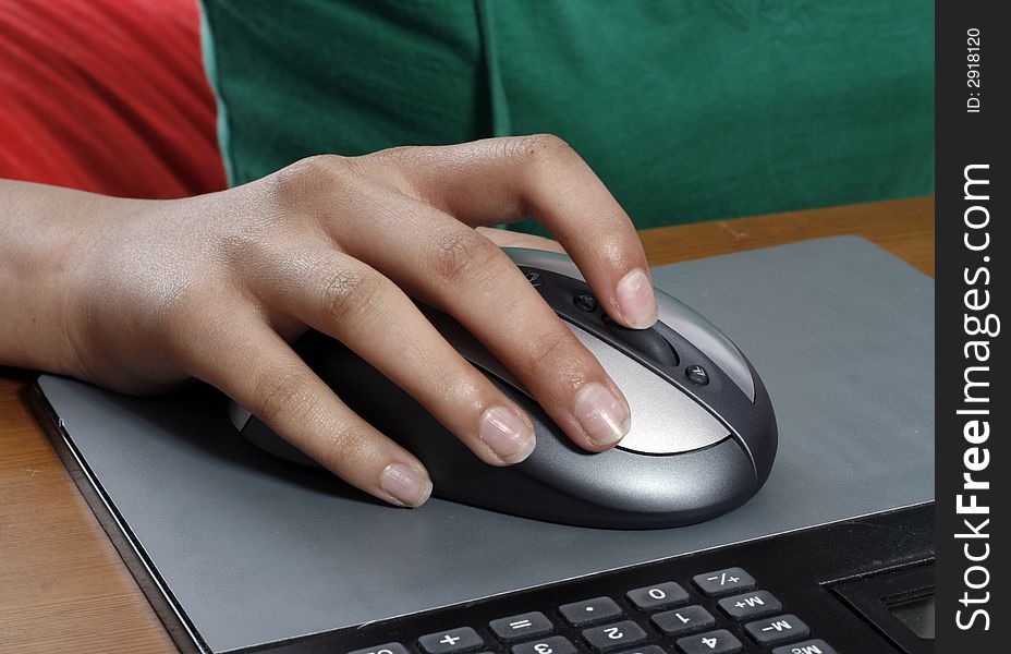 A girls hand on computer mouse. A girls hand on computer mouse