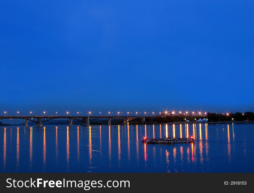 Night view on the bridge with illuminated light and reflection water