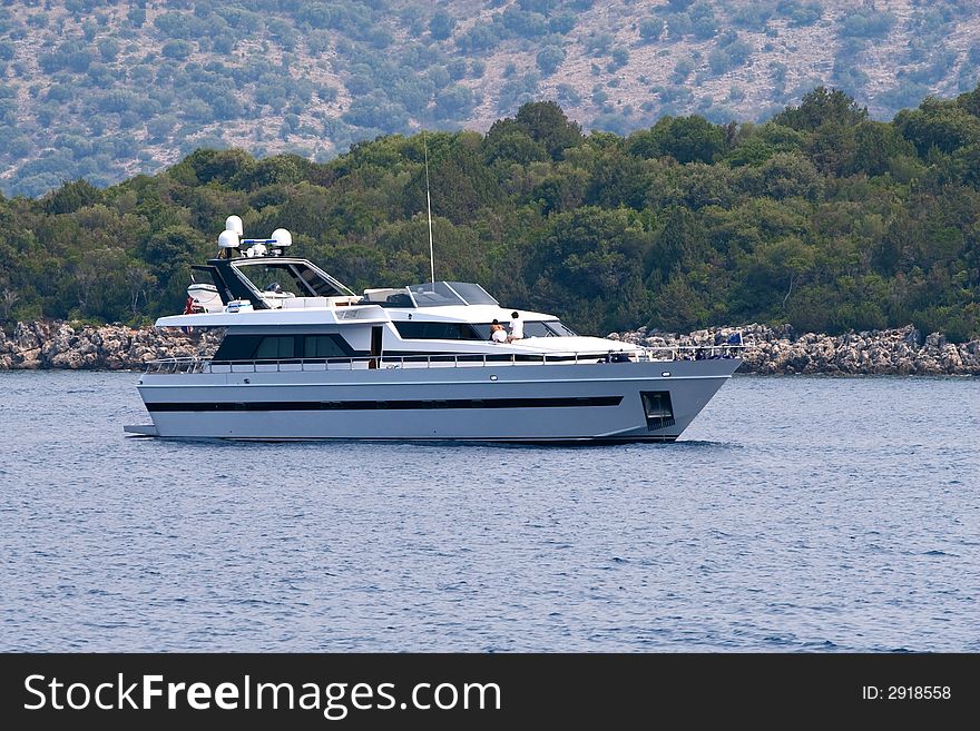 Luxury yacht on sea near olive tree forest