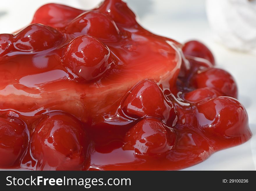 Cherry on a cake served with cherry sauce. Enjoy for dessert any day of the week. Cherry on a cake served with cherry sauce. Enjoy for dessert any day of the week.