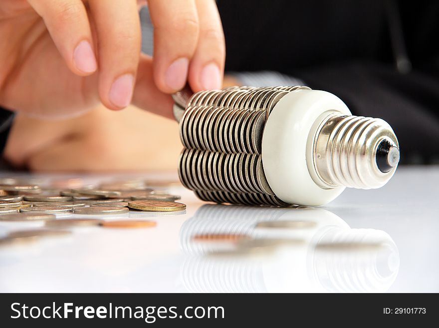 Abstract image of coin light bulb, energy concept