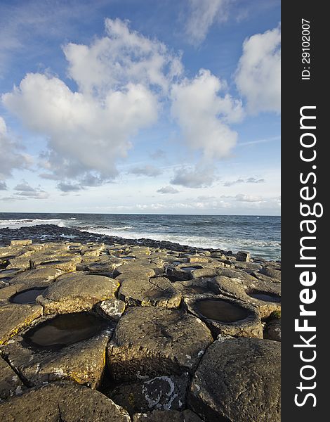 Sunny day at the Giant's Causeway - on the Antrim coast of Northern Ireland - UNESCO World Heritage Site. Sunny day at the Giant's Causeway - on the Antrim coast of Northern Ireland - UNESCO World Heritage Site.