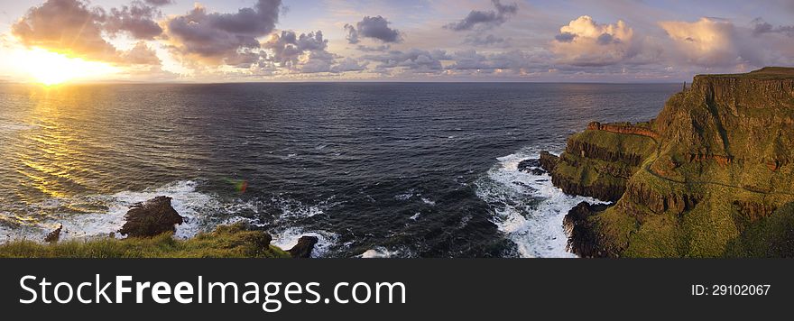 Panorama of the sunset and Lacada Point - part of the Giant s Causeway