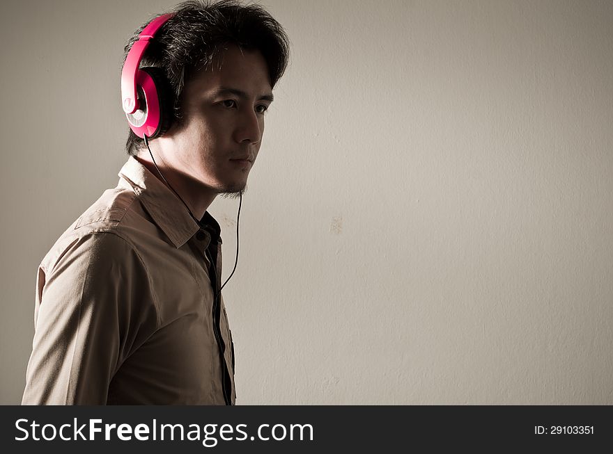 Man in shadow with headphone on his head. Man in shadow with headphone on his head