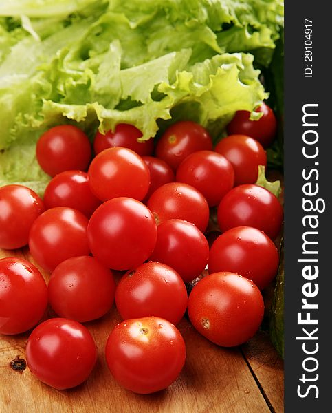 Red Cherry Tomatoes On A Wooden Board