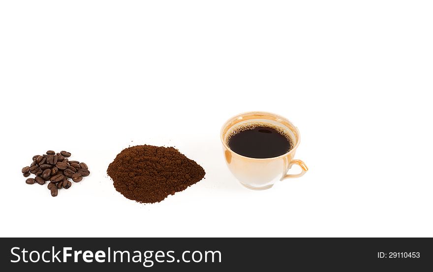 Freshly brewed cip of coffee and its ingredients with whole roasted coffee beans and a pile of freshly ground coffee isolated on white
