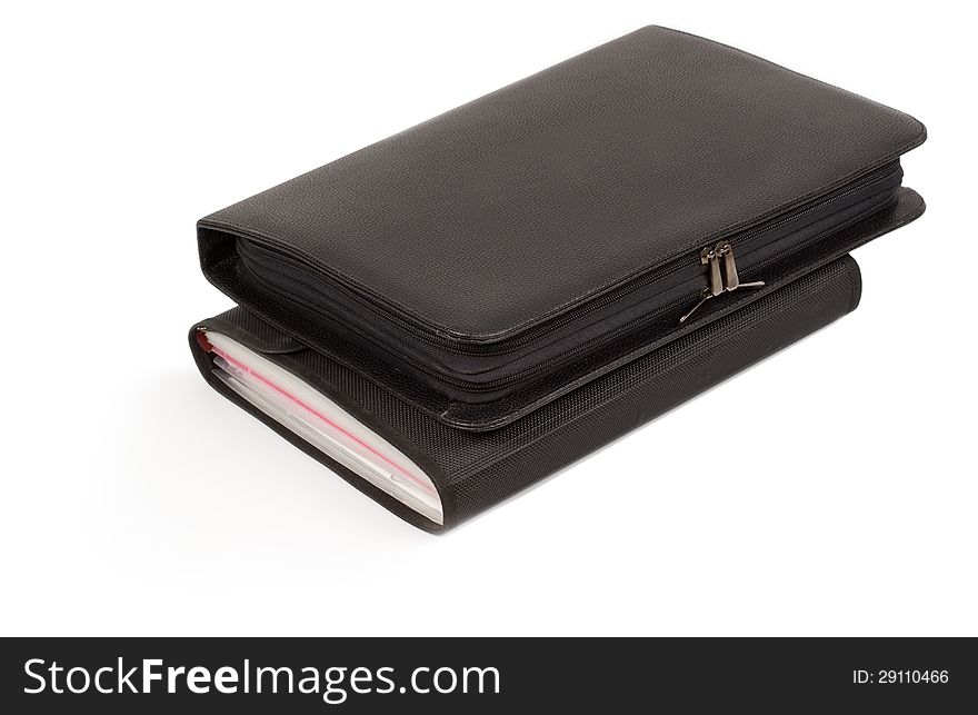 Two different closed black leather diaries or journals stacked one on top of each other isolated on a white background. Two different closed black leather diaries or journals stacked one on top of each other isolated on a white background