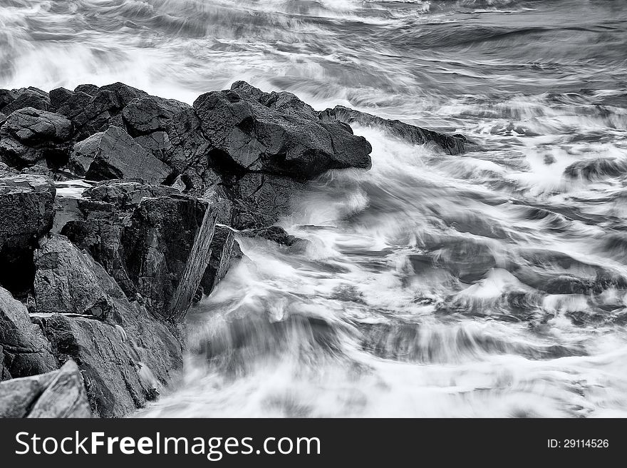 Waves crashing onto a rocky ledge