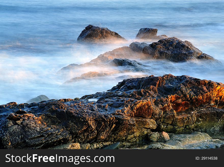 Wave action washing over coastal rocks on the New England Coast. Wave action washing over coastal rocks on the New England Coast