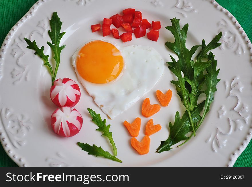 Heart shaped fried egg on beautiful plate. Heart shaped fried egg on beautiful plate.