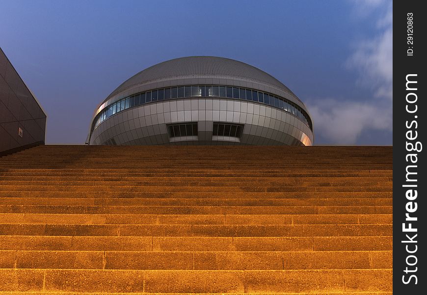 Stone stairs going toward futuristic building by night. Stone stairs going toward futuristic building by night