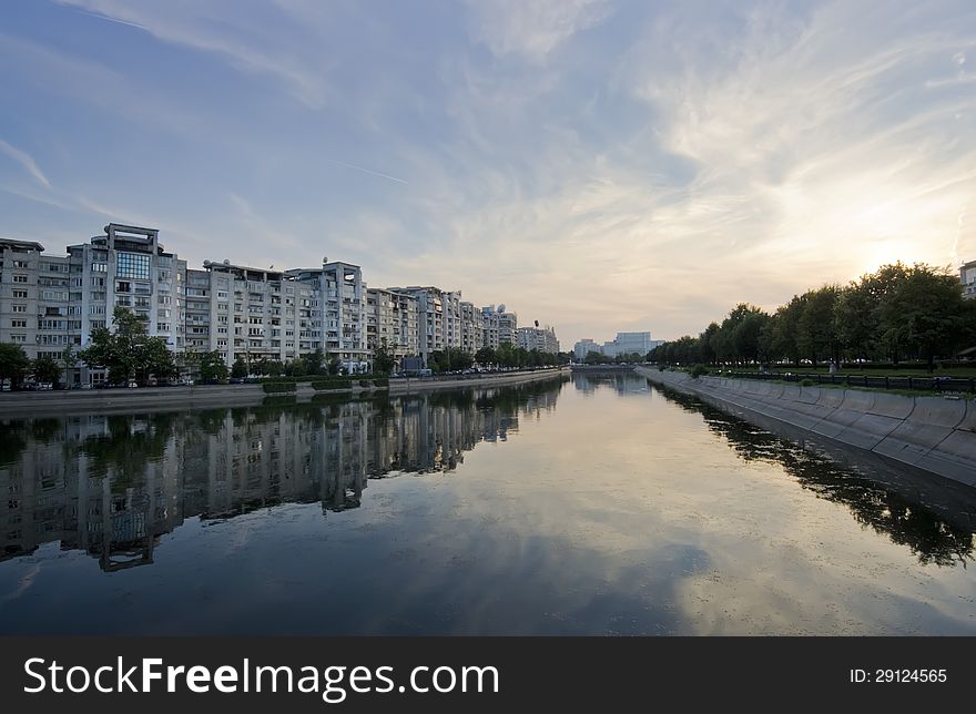 Dambovita river and buildings reflected in water, Bucharest. Romania