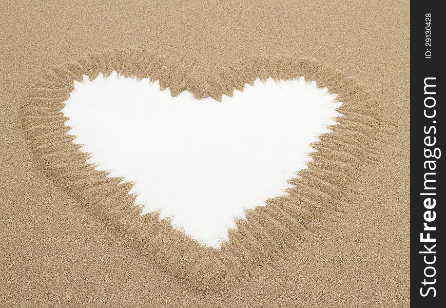 Heart shape drawn in sand with white space for text, conceptual designs