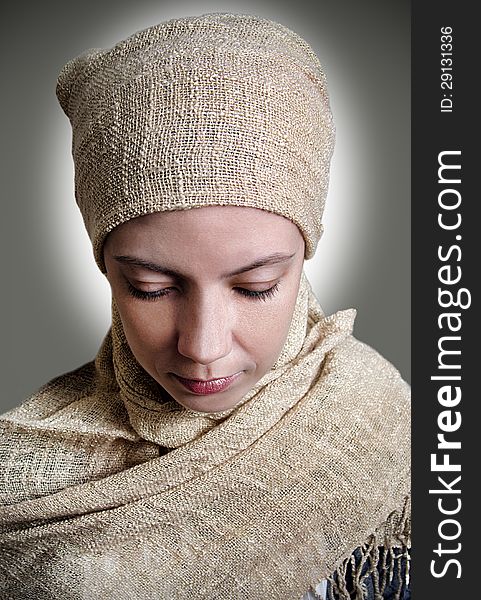 Close-up of a girl in a scarf looked down