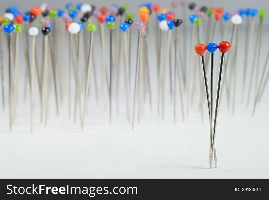 Different colored pins standing with background