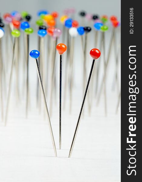 Different colored pins standing with background