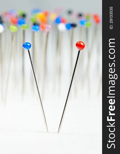 Different colored pins standing with background