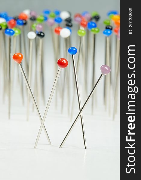 Different colored pins standing with background