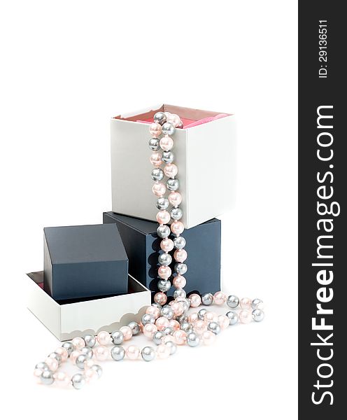 Grey gift boxes with pearl beads on white background. Grey gift boxes with pearl beads on white background