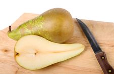 Pear, Knife And Chopping Board Closeup Royalty Free Stock Photo