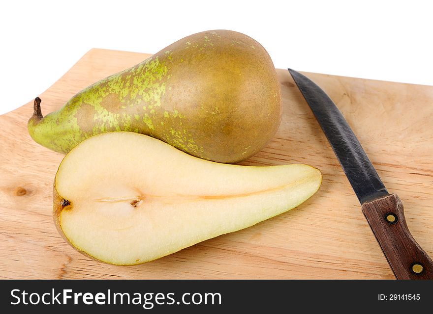 Pear, knife and chopping board closeup