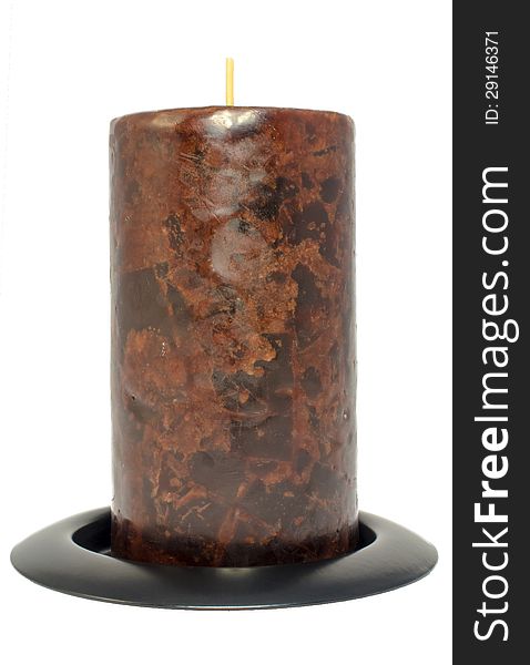 Dark candle stands on a circular base