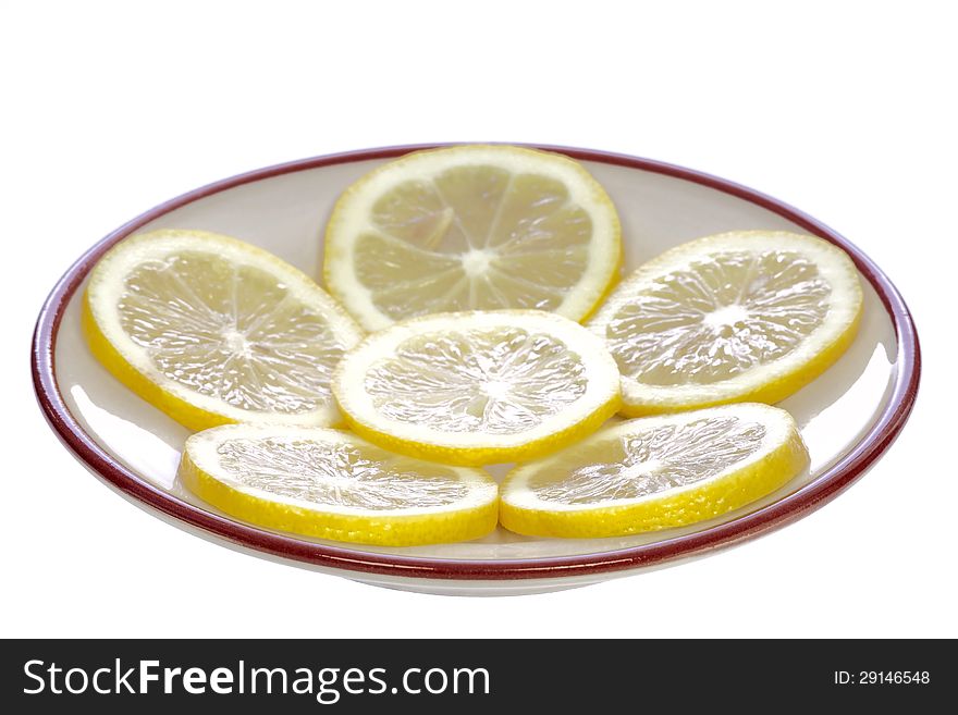 Lemons on a ceramic saucer, isolated on white background. Lemons on a ceramic saucer, isolated on white background