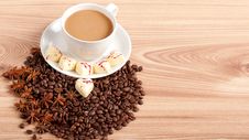 Cup Of Coffee With Beans And White Chocolate Heart Candy Over Wooden Background Royalty Free Stock Images Cup Of Coffee With Beans And White Chocolate Heart Candy Over Wooden Background Royalty Free Stock Images