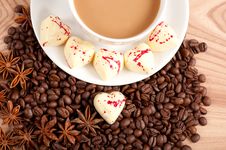 Cup Of Coffee With Beans And White Chocolate Heart Candy Over Wooden Background Royalty Free Stock Image Cup Of Coffee With Beans And White Chocolate Heart Candy Over Wooden Background Royalty Free Stock Image